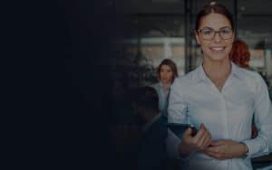 Business woman using tablet in front of her colleagues in the office.