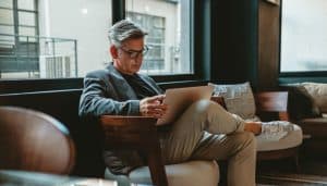 Man working while sitting on lounge